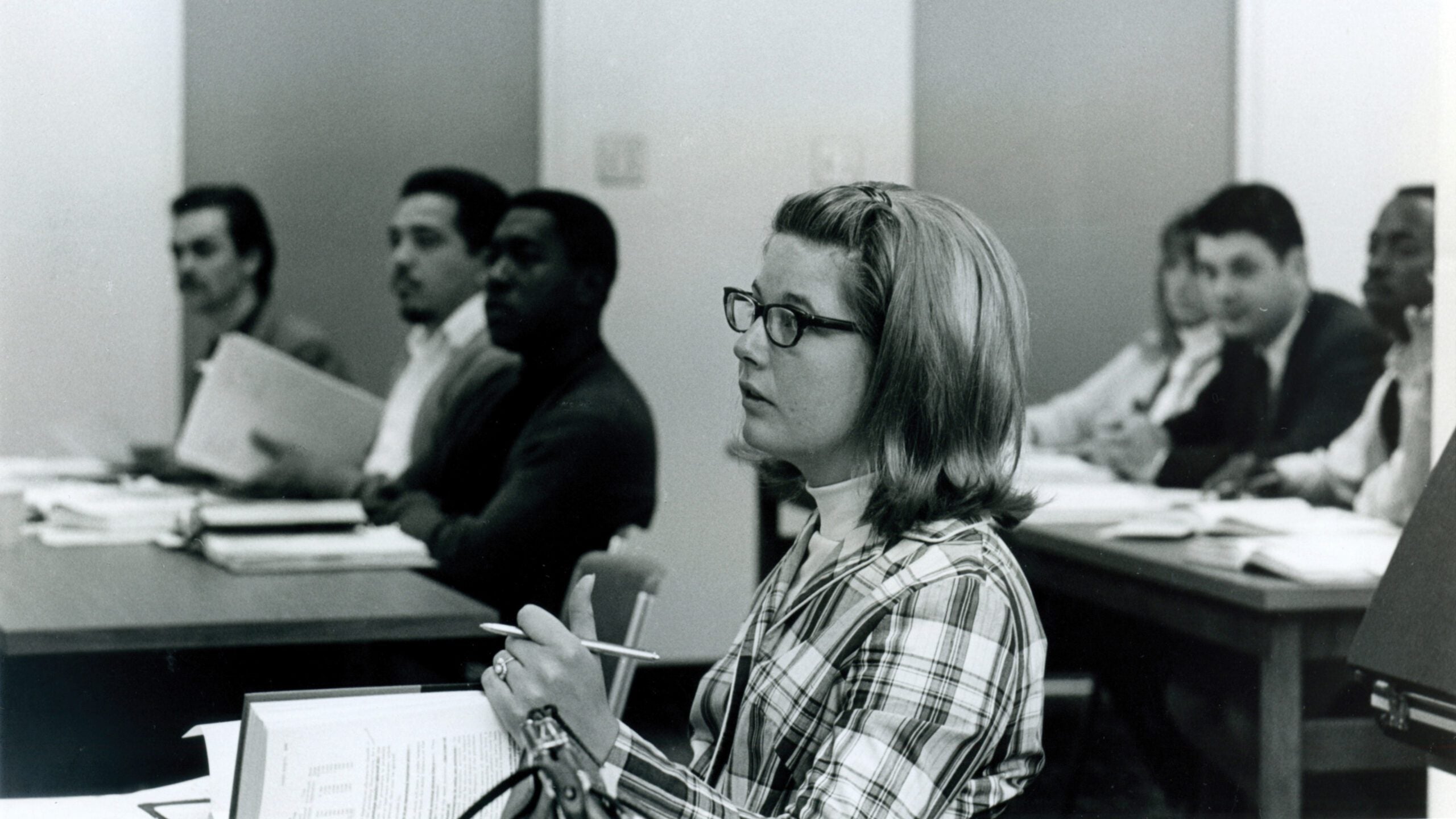 Student asking question in classroom.